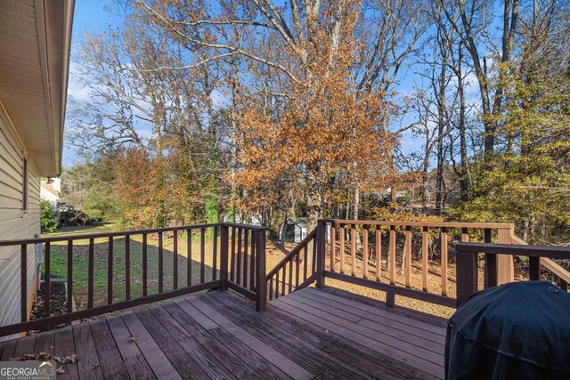 wooden terrace featuring grilling area