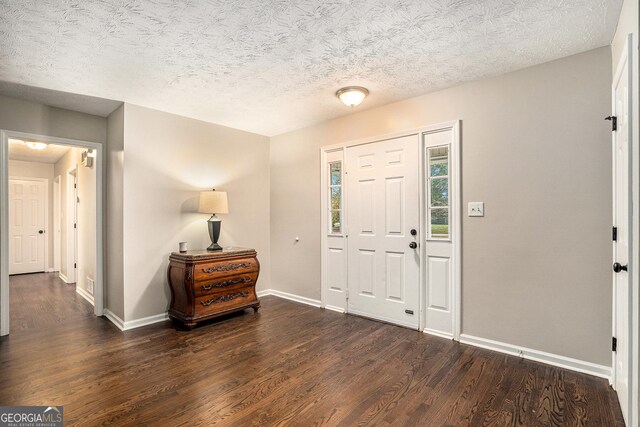 entryway featuring a textured ceiling and dark hardwood / wood-style floors