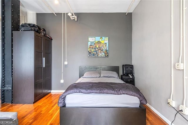 bedroom with hardwood / wood-style flooring