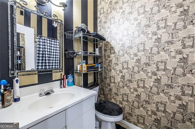 bathroom featuring vanity and toilet