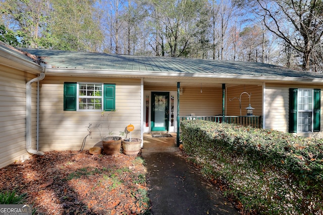 view of exterior entry featuring a porch