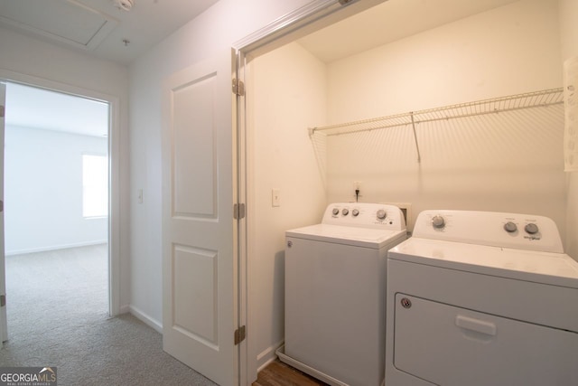 laundry room featuring dark carpet and washer and clothes dryer