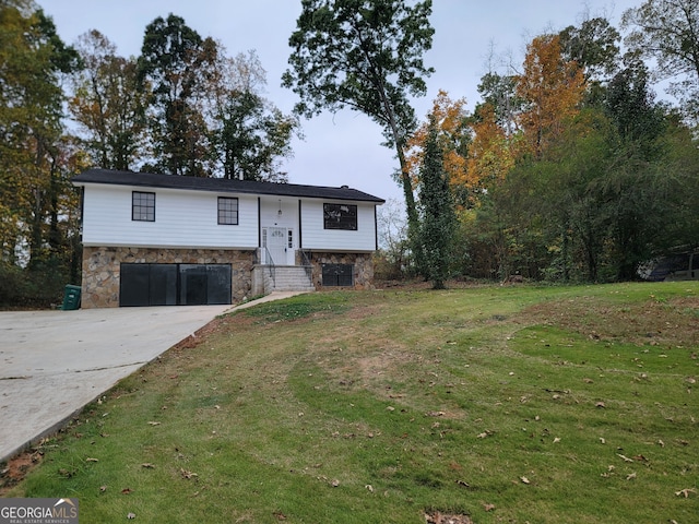 split foyer home with a front lawn and a garage