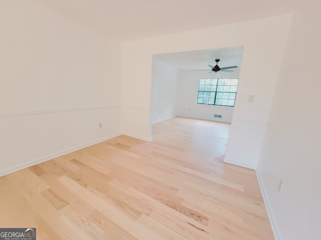 empty room with light wood-type flooring and ceiling fan