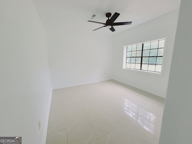 unfurnished room with ceiling fan and light tile patterned floors