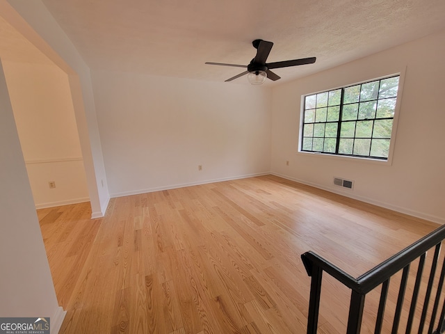 unfurnished room featuring ceiling fan and light hardwood / wood-style floors