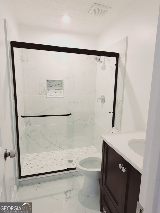 bathroom with walk in shower, vanity, and toilet