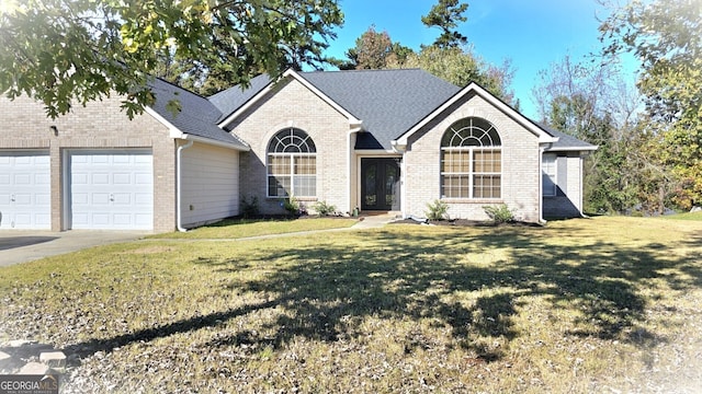 ranch-style home featuring a garage and a front lawn