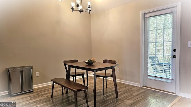 dining room featuring hardwood / wood-style floors and an inviting chandelier