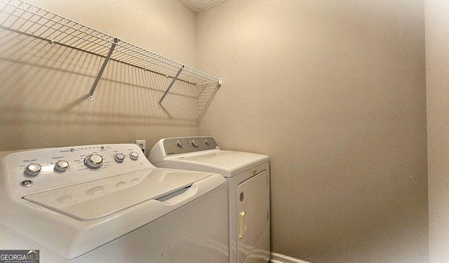 clothes washing area with independent washer and dryer