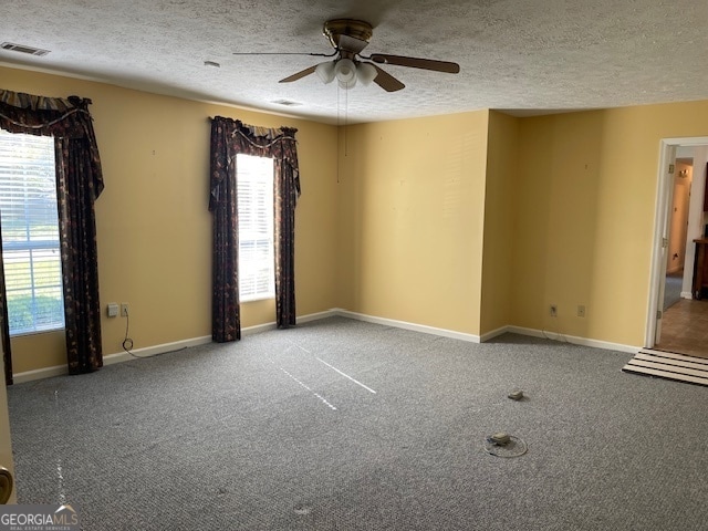 empty room featuring carpet, a textured ceiling, and ceiling fan