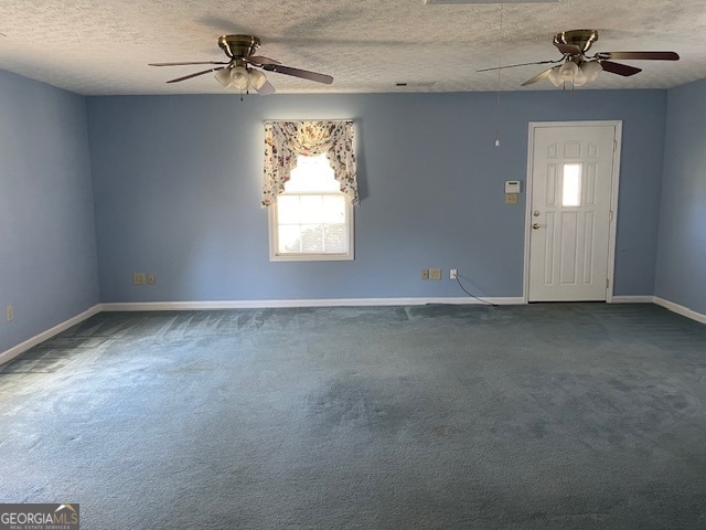 spare room featuring carpet flooring, a textured ceiling, and ceiling fan