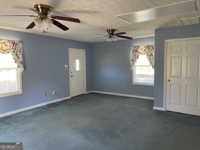 carpeted foyer featuring a textured ceiling and ceiling fan