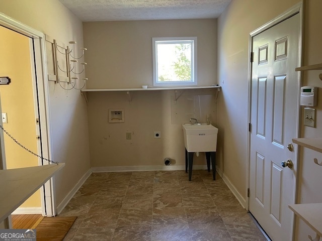 washroom with washer hookup, a textured ceiling, and hookup for an electric dryer