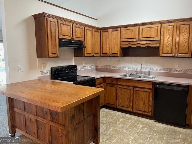 kitchen featuring sink, black appliances, vaulted ceiling, butcher block countertops, and decorative backsplash