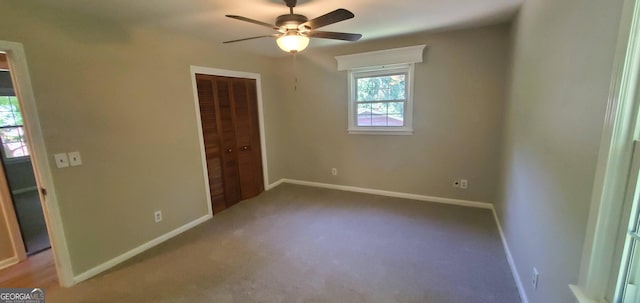 unfurnished bedroom with ceiling fan, a closet, and carpet floors