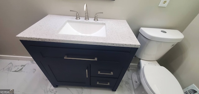 bathroom featuring vanity and toilet