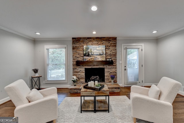 living room featuring dark hardwood / wood-style flooring, ornamental molding, and a healthy amount of sunlight