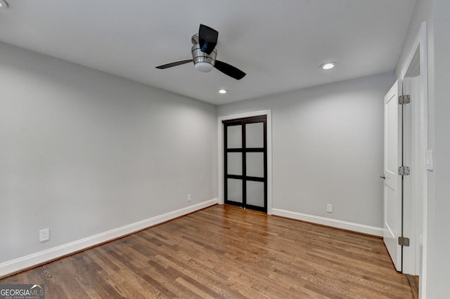 unfurnished room featuring ceiling fan and light hardwood / wood-style flooring