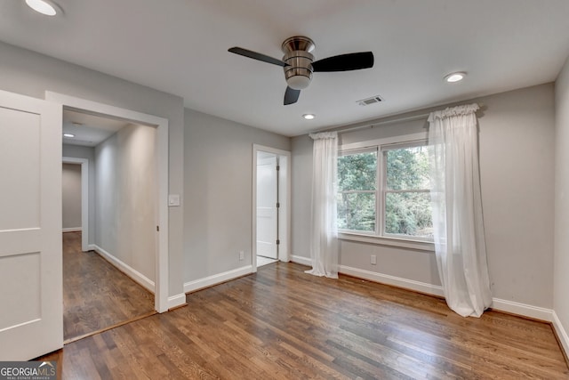 unfurnished bedroom featuring hardwood / wood-style floors and ceiling fan