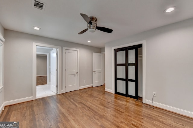 unfurnished bedroom featuring light hardwood / wood-style floors and ceiling fan