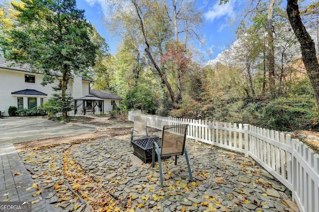 view of patio / terrace with a fire pit and a gazebo