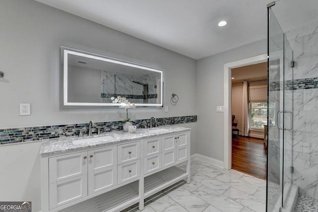 bathroom with hardwood / wood-style flooring, vanity, and an enclosed shower