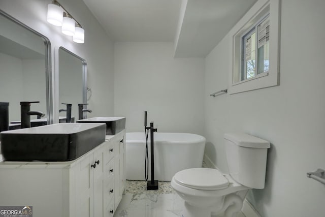 bathroom with a bath, vanity, and toilet