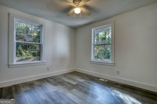 unfurnished room featuring ceiling fan and dark hardwood / wood-style floors