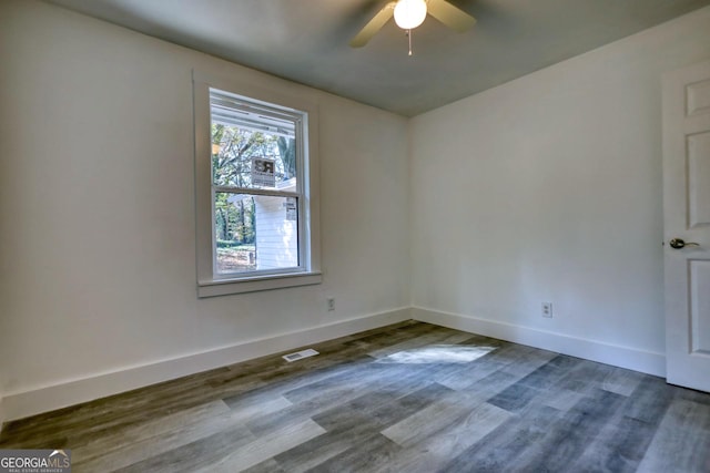 spare room featuring ceiling fan and dark hardwood / wood-style floors