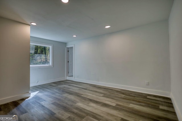 spare room with dark wood-type flooring