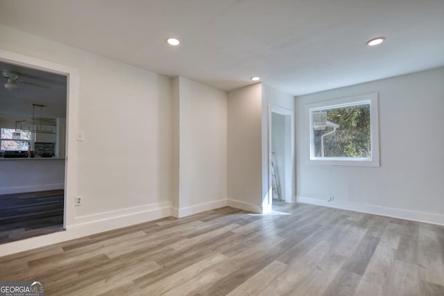 unfurnished room with light wood-type flooring