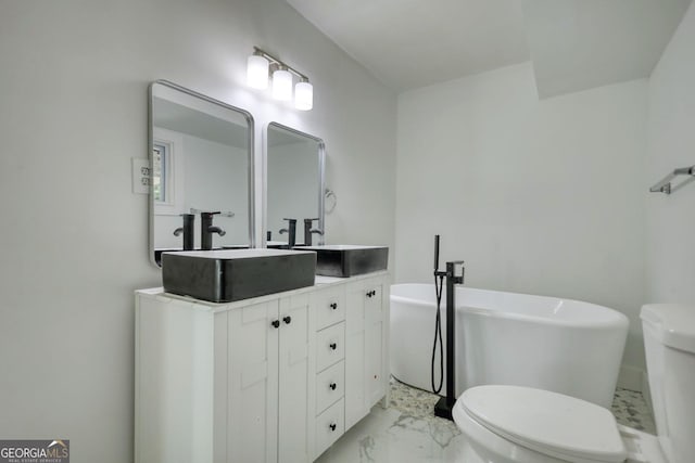 bathroom featuring a bathtub, toilet, and vanity