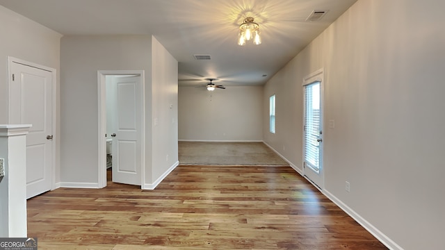 spare room with ceiling fan and light wood-type flooring