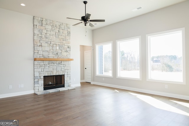 unfurnished living room with ceiling fan, hardwood / wood-style floors, and a fireplace