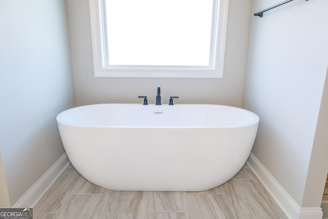 bathroom with a tub to relax in