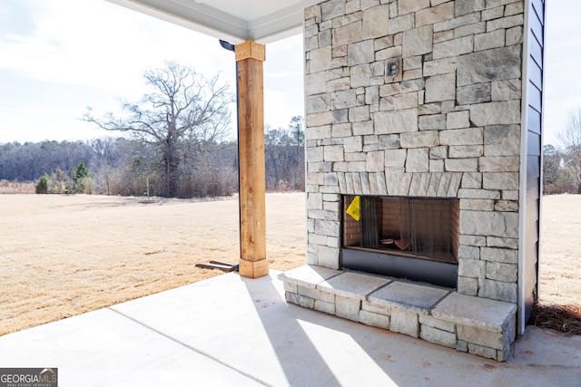 view of patio featuring an outdoor stone fireplace