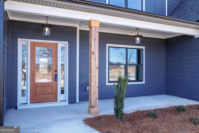 view of exterior entry with covered porch