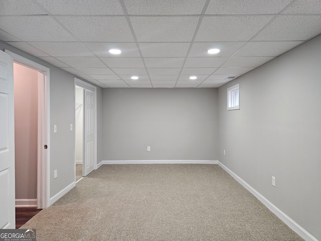 unfurnished room with carpet floors and a drop ceiling