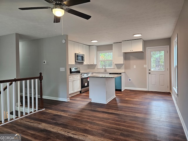 kitchen with white cabinetry, a wealth of natural light, a center island, and stainless steel appliances