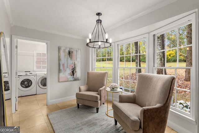 sitting room with washer and clothes dryer, a notable chandelier, a healthy amount of sunlight, and ornamental molding