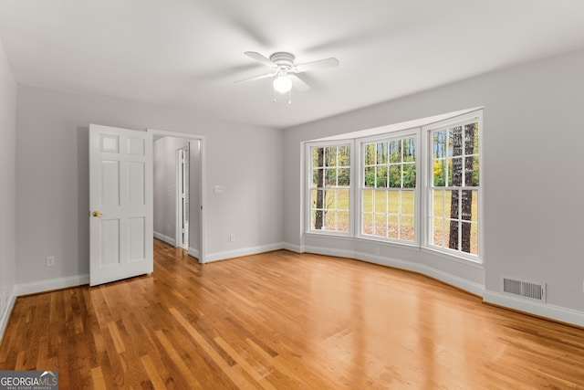 unfurnished room featuring ceiling fan and light wood-type flooring