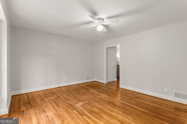 empty room featuring ceiling fan and hardwood / wood-style flooring