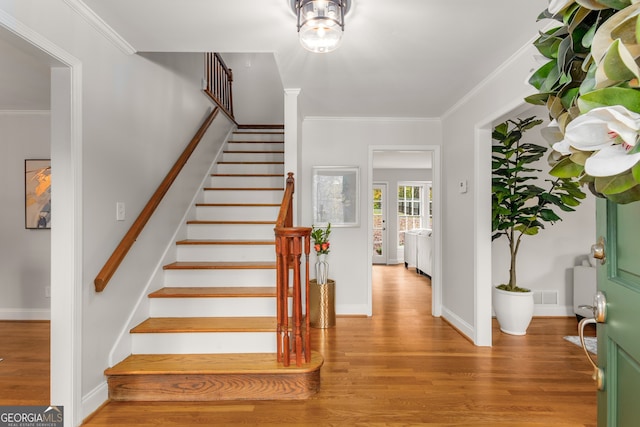 entrance foyer featuring light hardwood / wood-style floors and ornamental molding