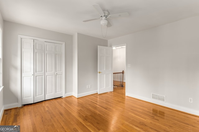 unfurnished bedroom with a closet, light hardwood / wood-style flooring, and ceiling fan