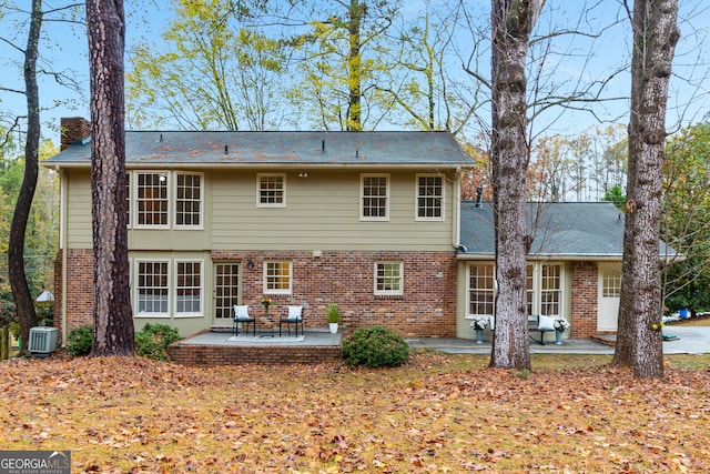 back of property with cooling unit and a patio area