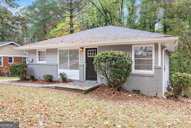 ranch-style home with a front lawn