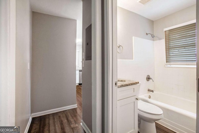 full bathroom featuring toilet, vanity, wood-type flooring, and bathing tub / shower combination