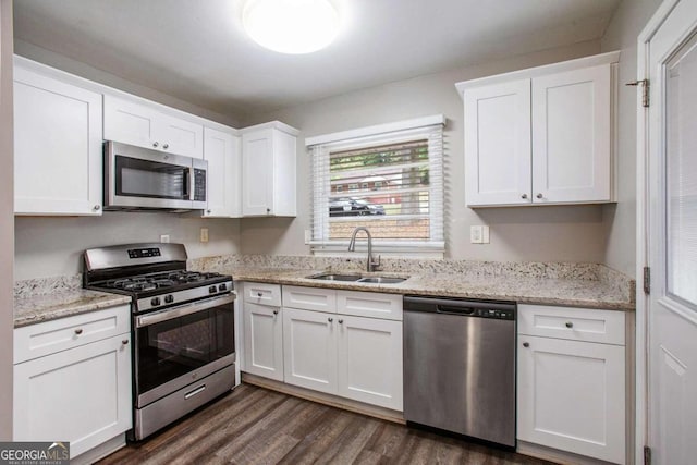 kitchen with dark wood-type flooring, white cabinetry, appliances with stainless steel finishes, and sink