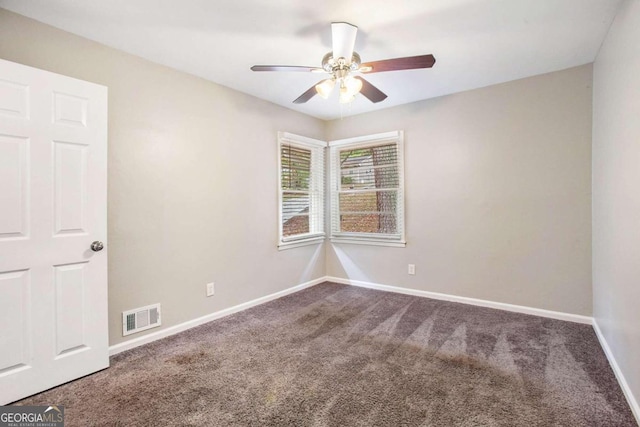 carpeted spare room with ceiling fan